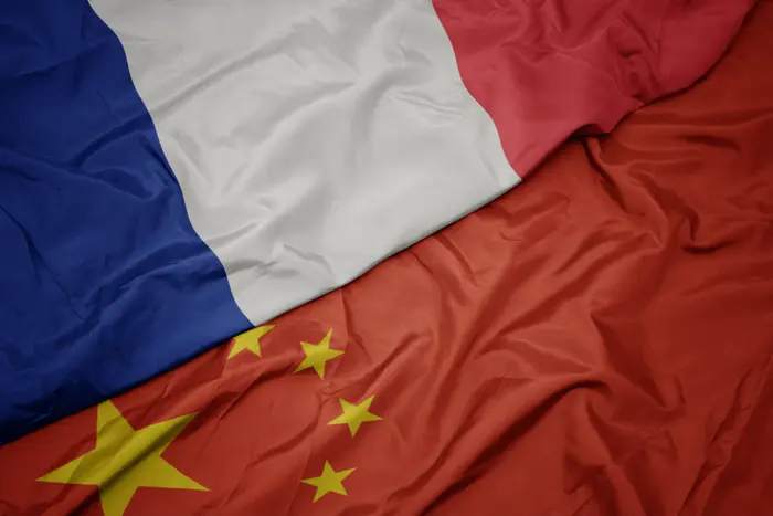 waving colorful flag of china and national flag of france. macro - waving colorful flag of china and national flag of france. - waving colorful flag o