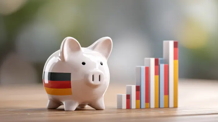 Economic Growth of Germany: A piggy bank adorned with German flag next to a rising bar graph, highlighting financial growth and the nation's economic 